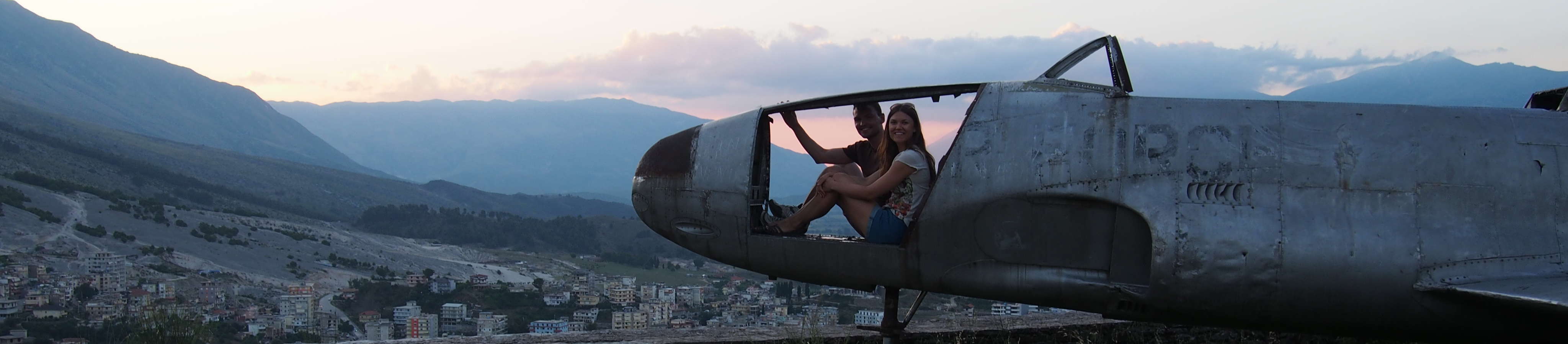 A photo of me and my wife on a wrecked US airplane in Gjirokastër Fortress
